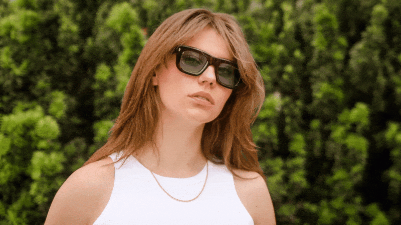 Campaign photography for Optician Kästner Stuttgart showing a model wearing sunglasses in a natural outdoor setting GIF